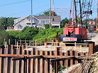 Street view of dormant crane at construction site.